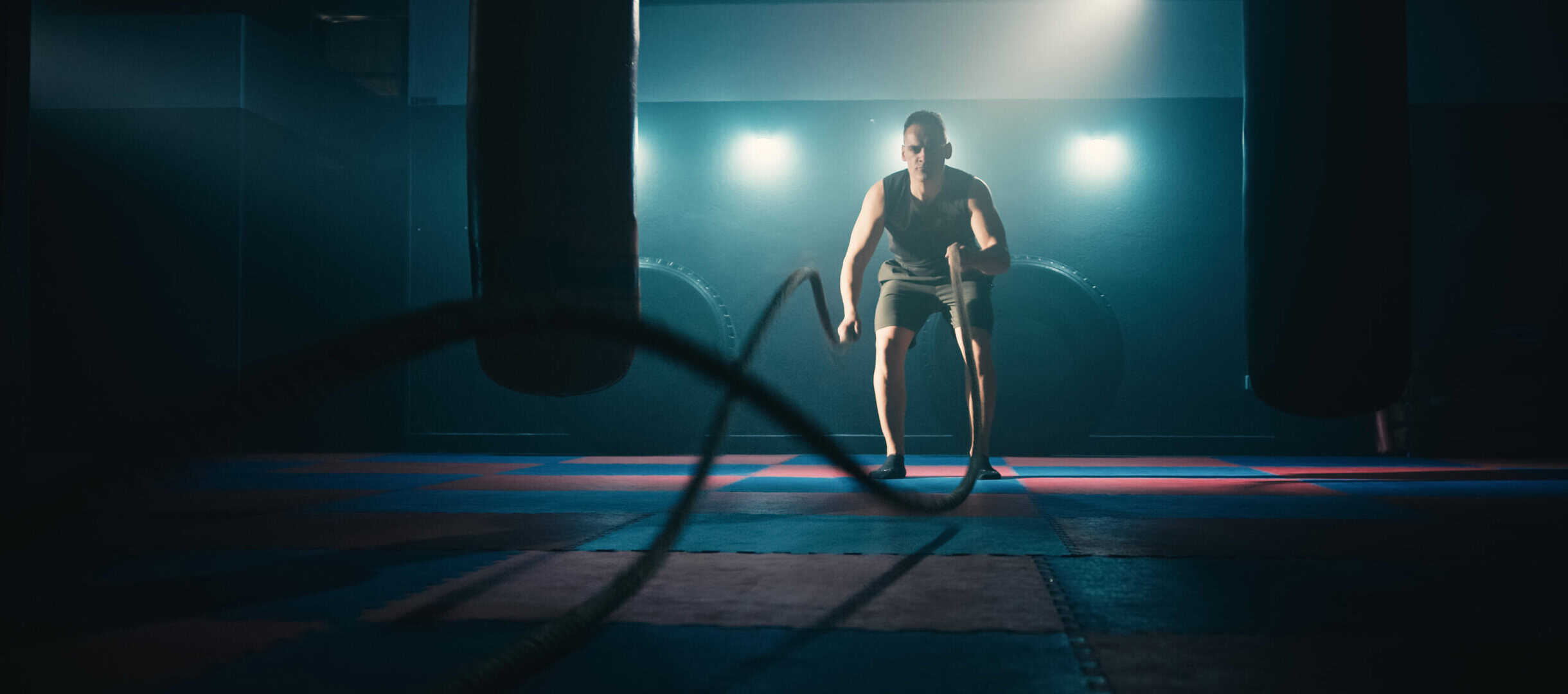 Fitness athlete training using battle ropes intense workout